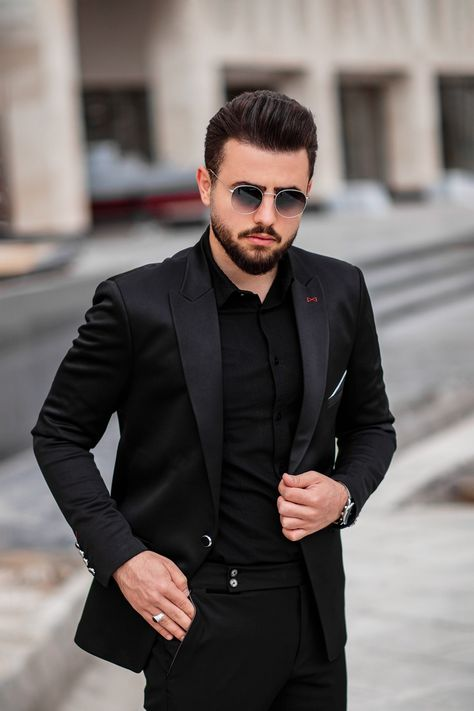 man wearing black suit with sunglasses