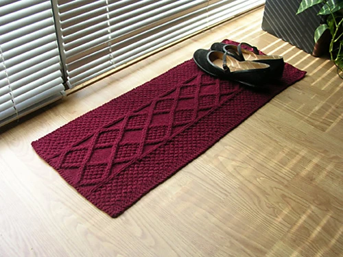 burgundy textured knit rug made from a single skein of yarn