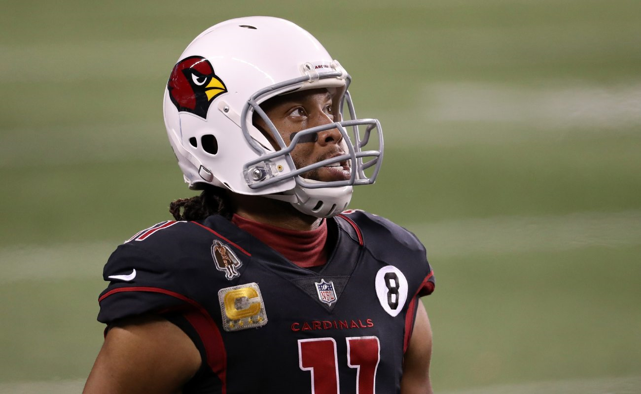 Arizona Cardinals’ Larry Fitzgerald  waits on the side of the field in full gear. 