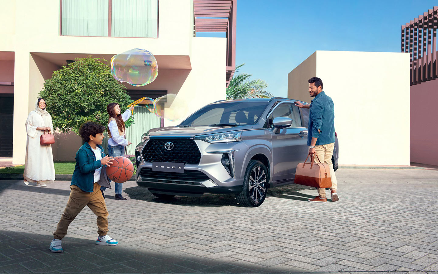 family standing outside with toyota veloz 