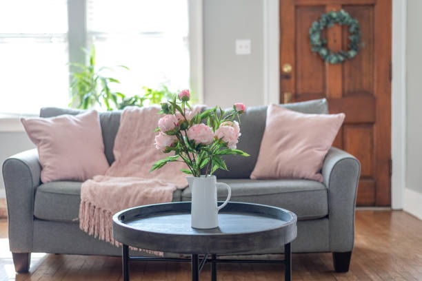 grey 3-seater sofa with pink throw pillows