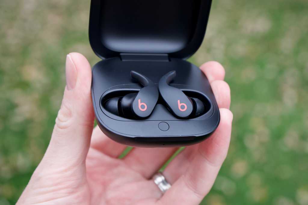 This image shows the Beats fit pro in the hands of a man.