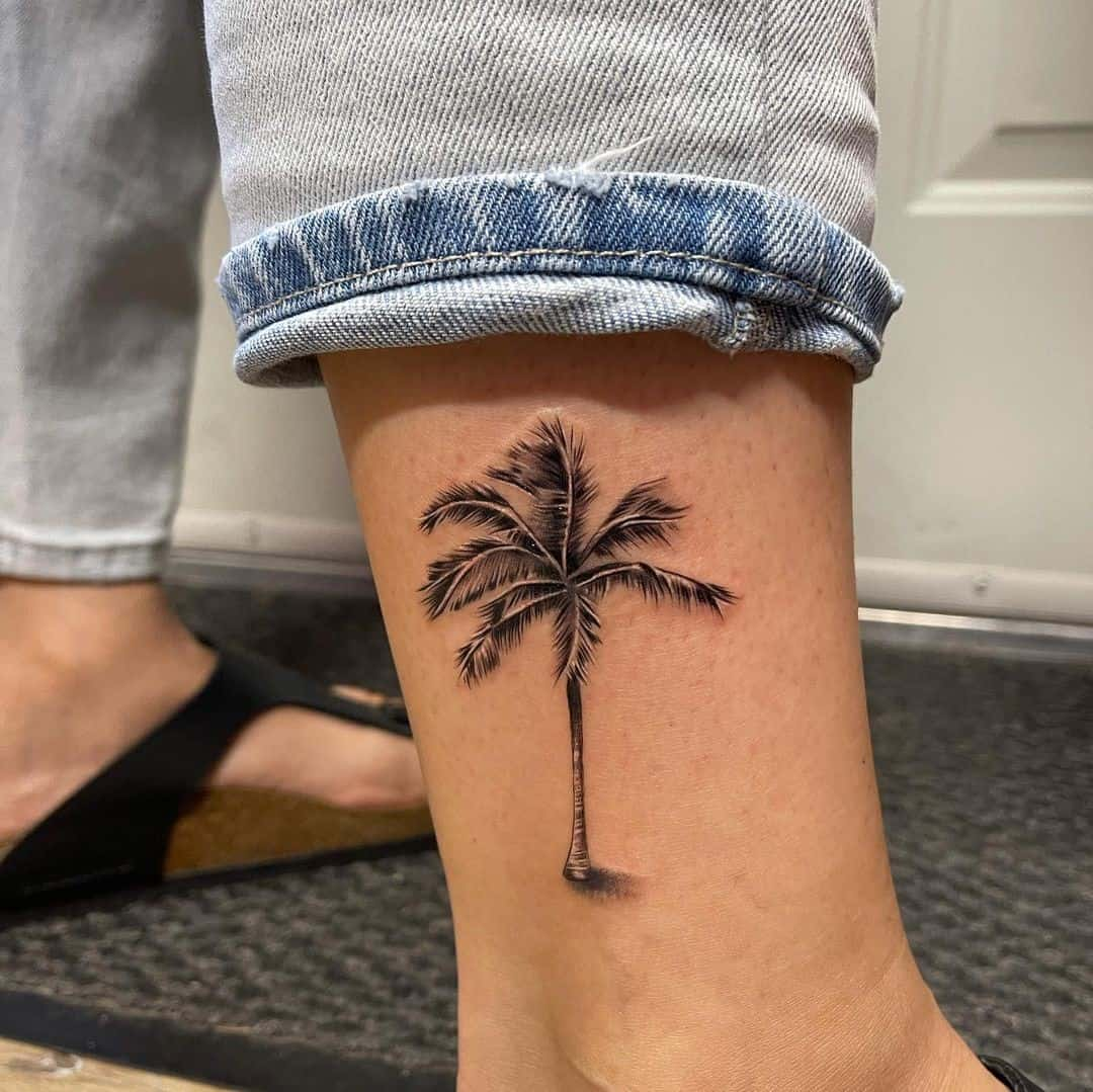 Full view of a guy rocking the palm tree on his ankle 