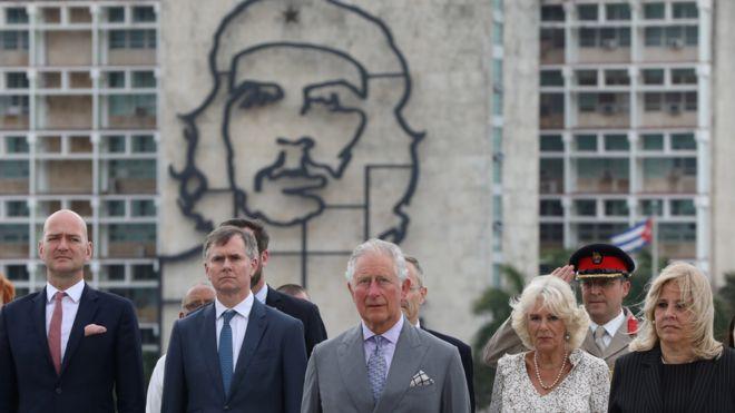 Prince Charles and Camilla standing near an image of late revolutionary hero Ernesto "Che" Guevara