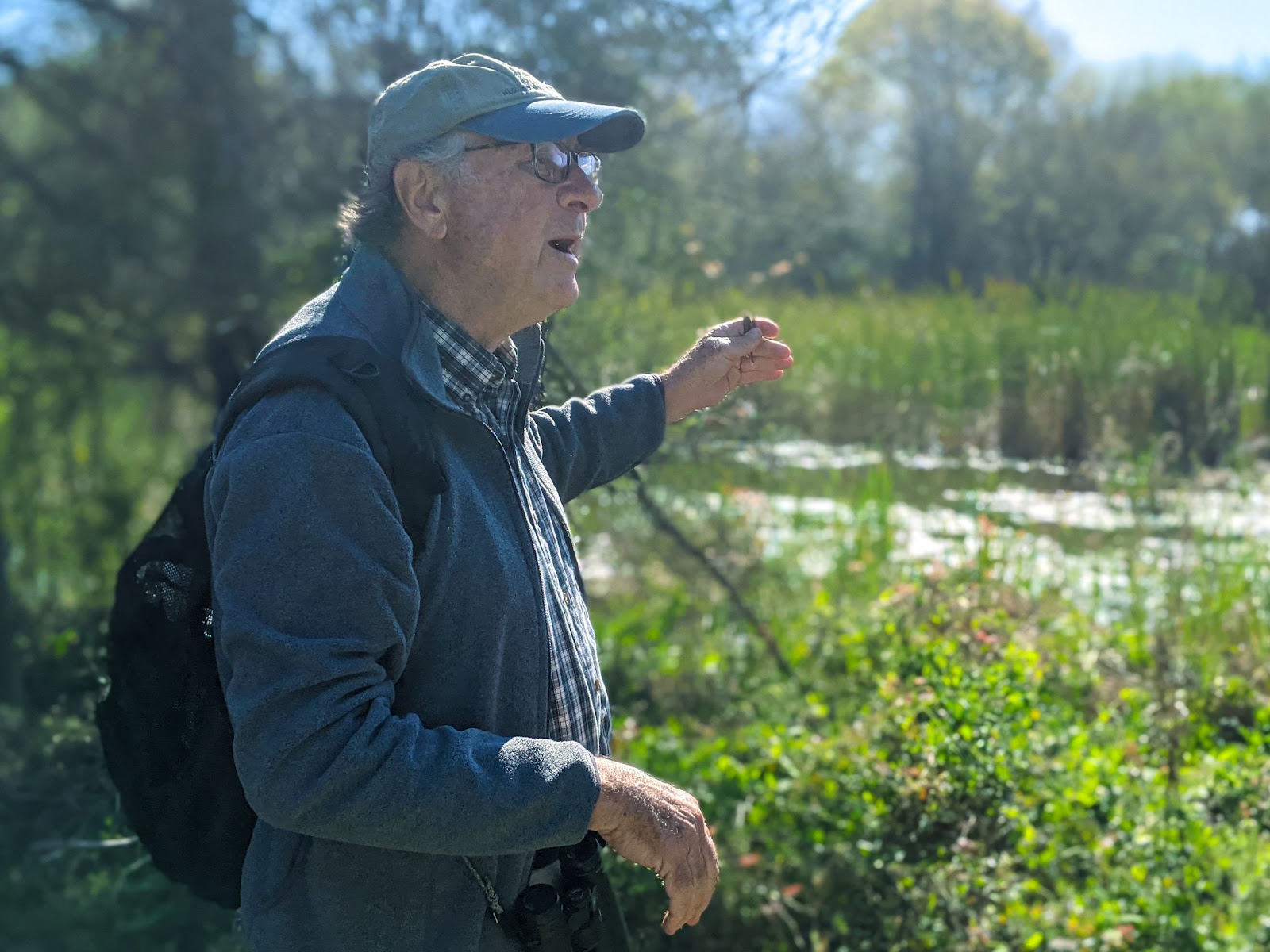 Glenn Olson identifies a bird as he leads a group of environmental journalists on a birding tour.