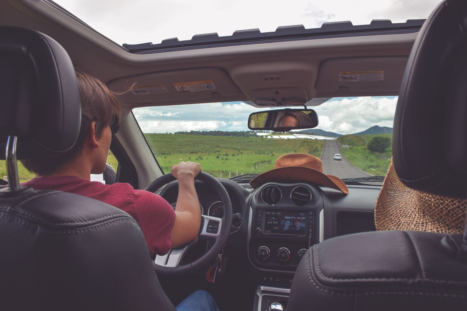 Backseat photo of a couple driving in the countryside