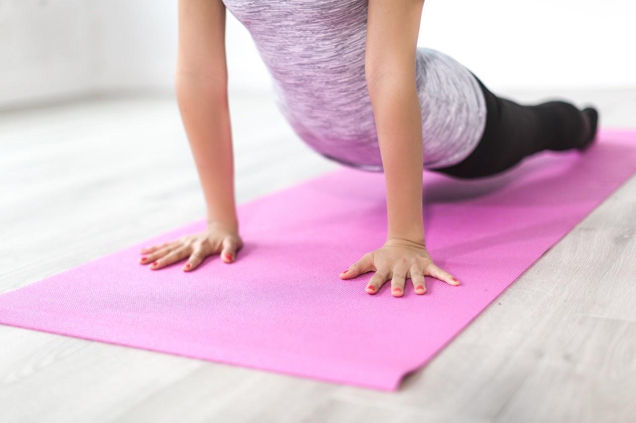 a woman on a yoga mat doing an asana correctly