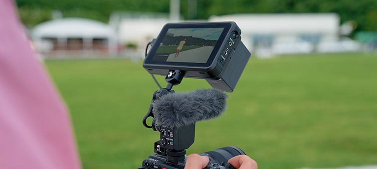 Holding the camera with monitor attached