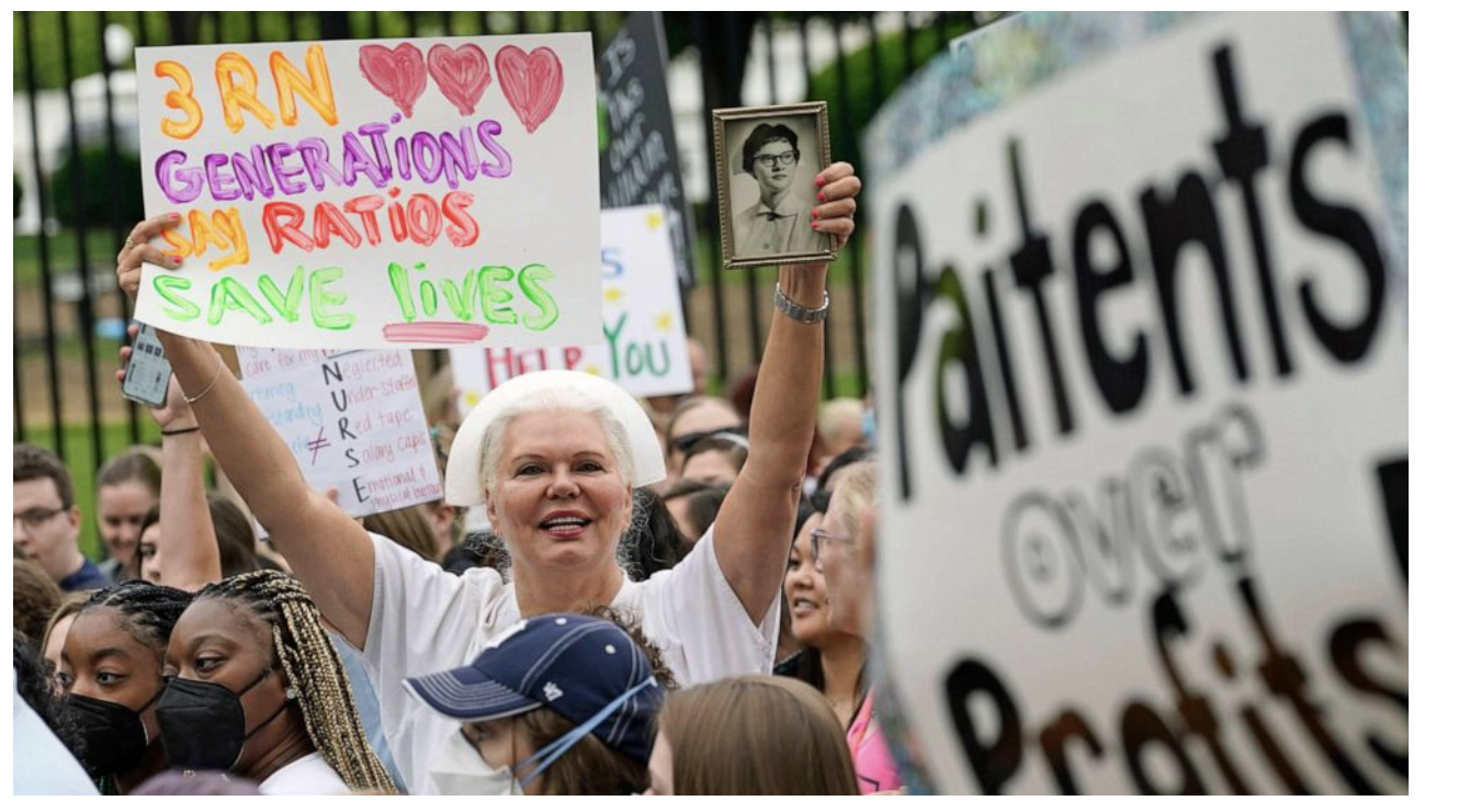 Woman holding sign and old black and white photo up to camera.