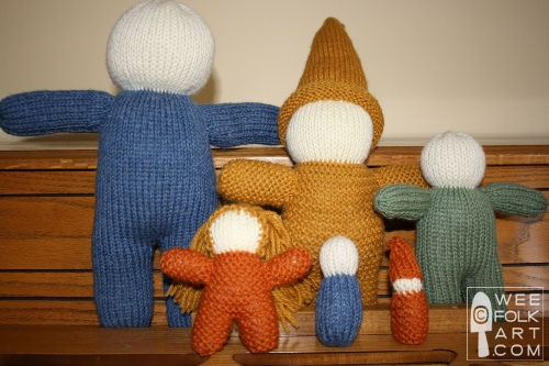 variety of sizes of knit doll bodies without faces