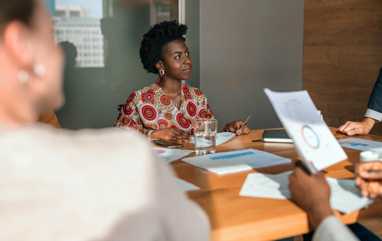 Female entrepreneur in a meeting with coworkers