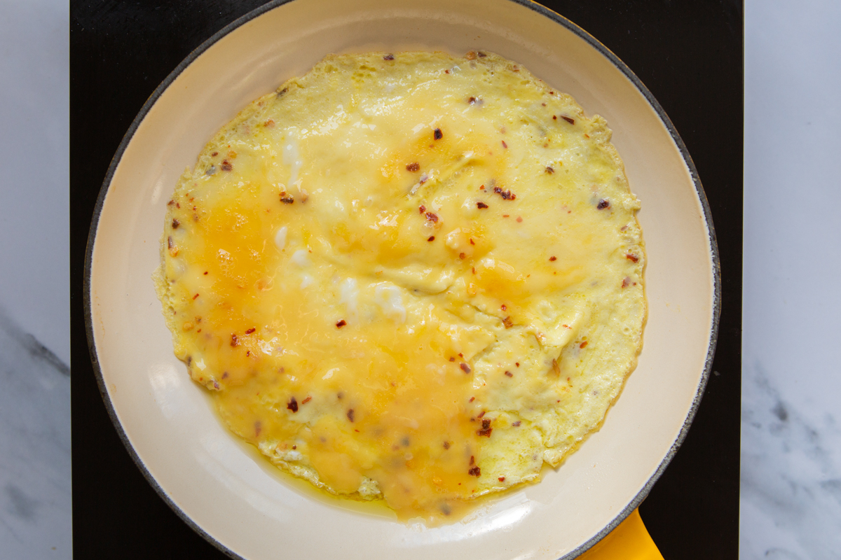 omelette cooking in a skillet
