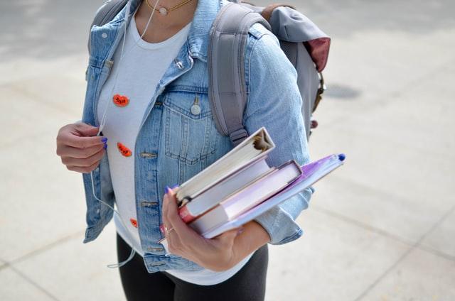 Student holding her textbooks.