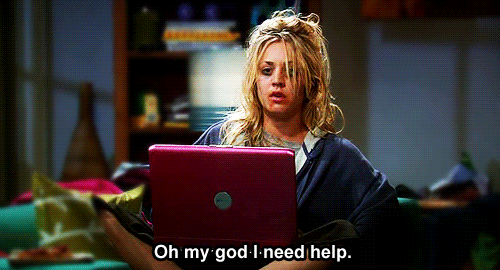 A woman with messy hair sitting behind a laptop looking extremely tired saying, "Oh my god I need help".