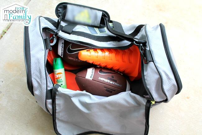 A gym bag filled with sports equipment.