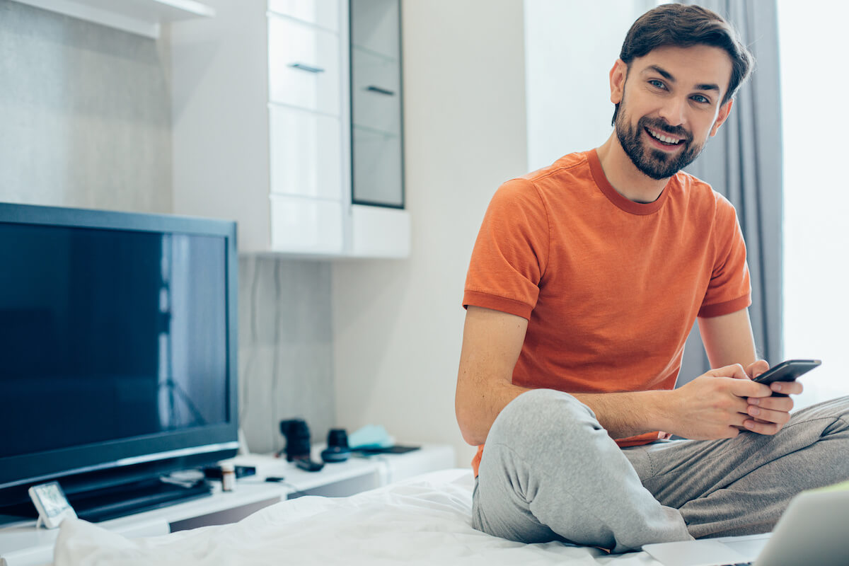 Patient engagement technology: happy man using his phone