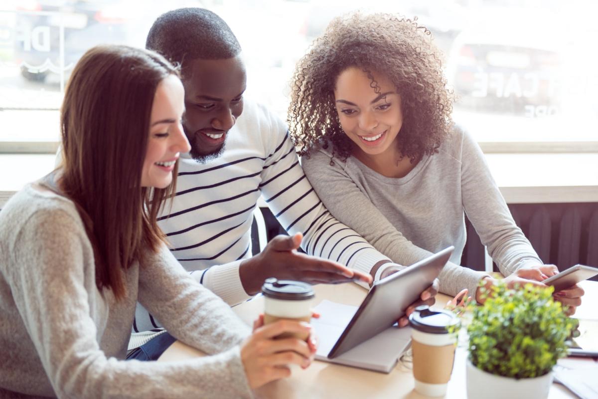 A group of people looking at a tablet