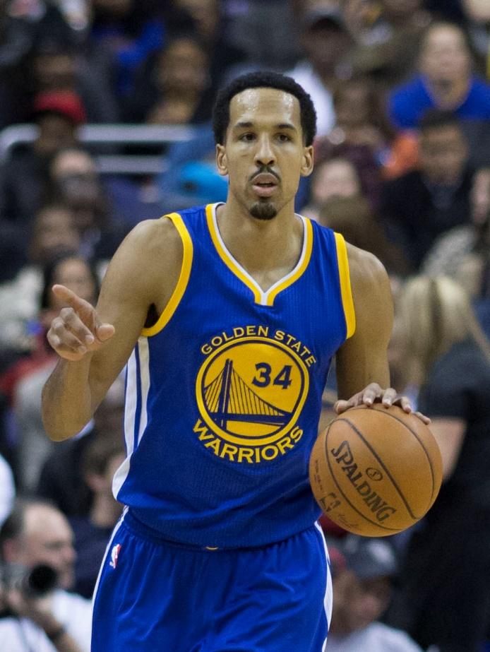A basketball player in front of a crowd

Description automatically generated