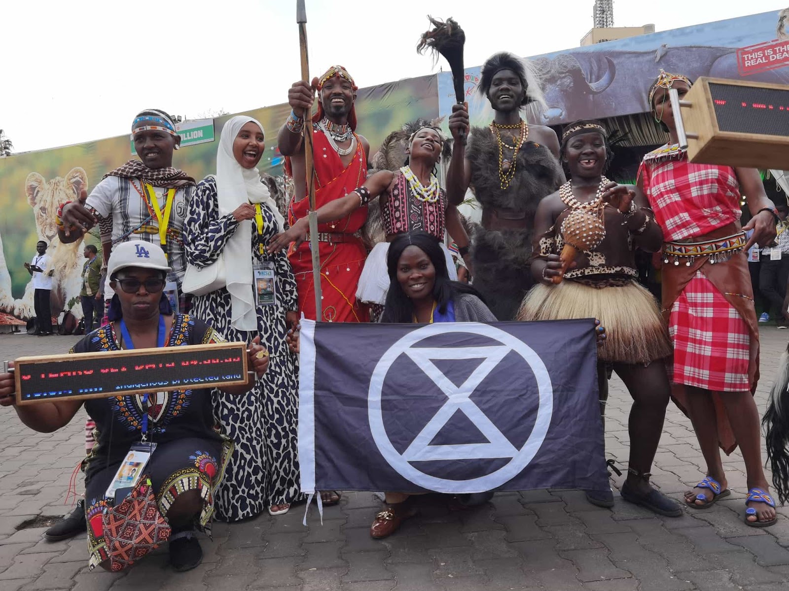 XR Kenya pose for a group photo outside the summit, some rebels in tribal dress.