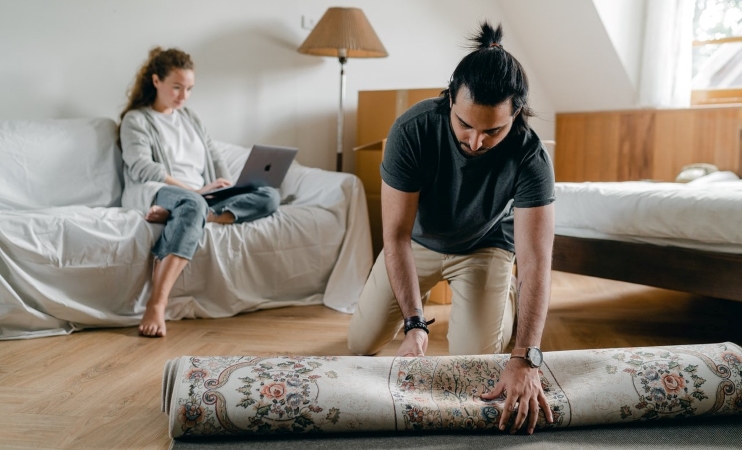 woman working from home while her partner packs for a move