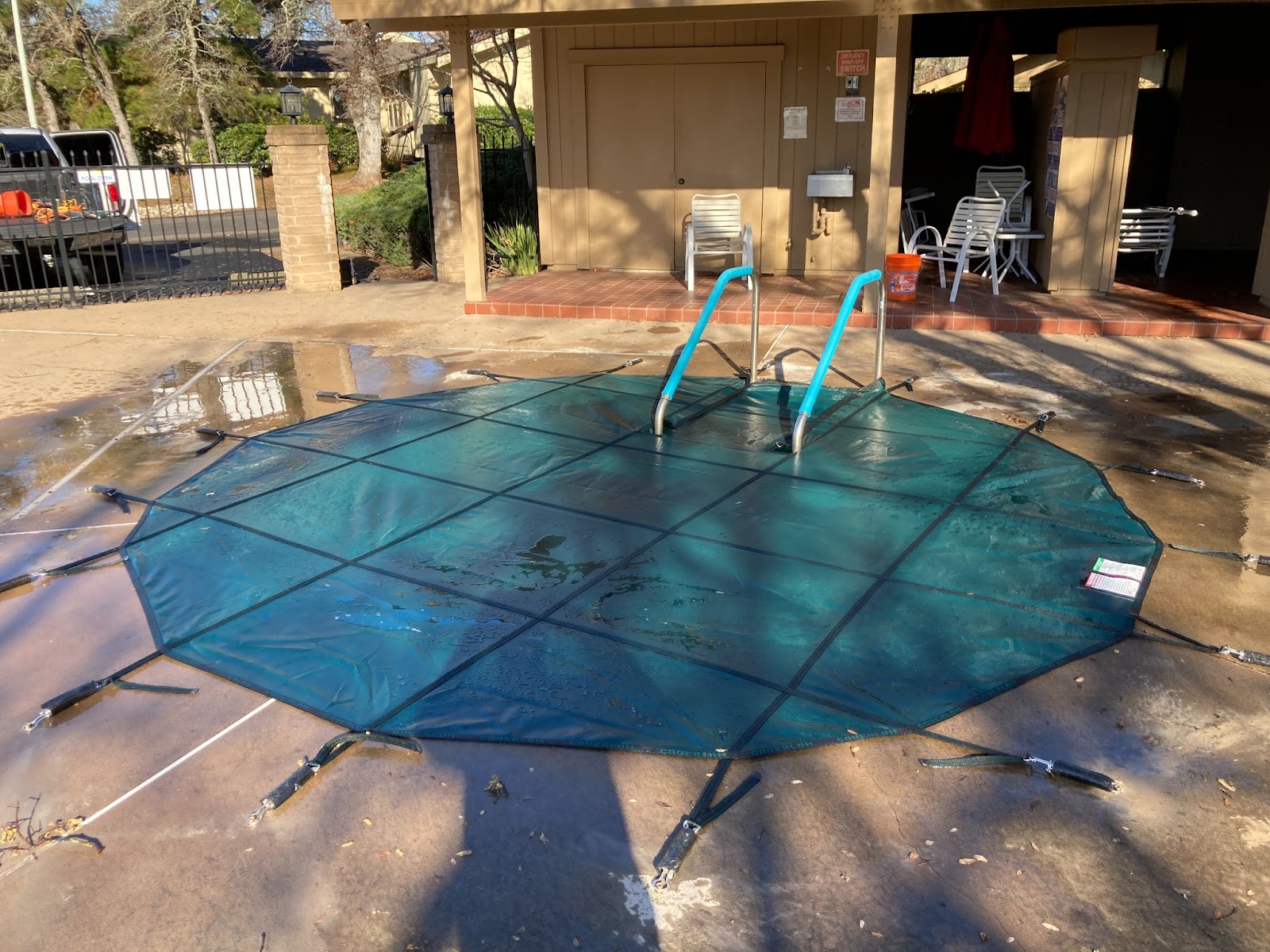 Green pool safety cover installed on a hot tub