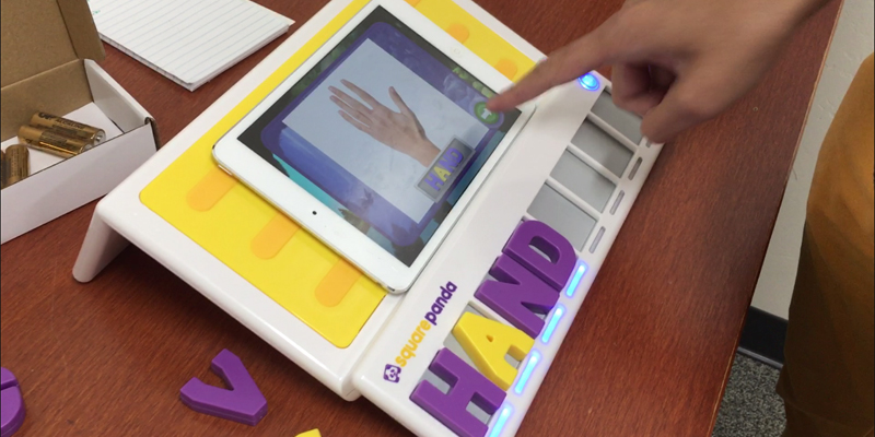 a student pointing to the square panda tablet