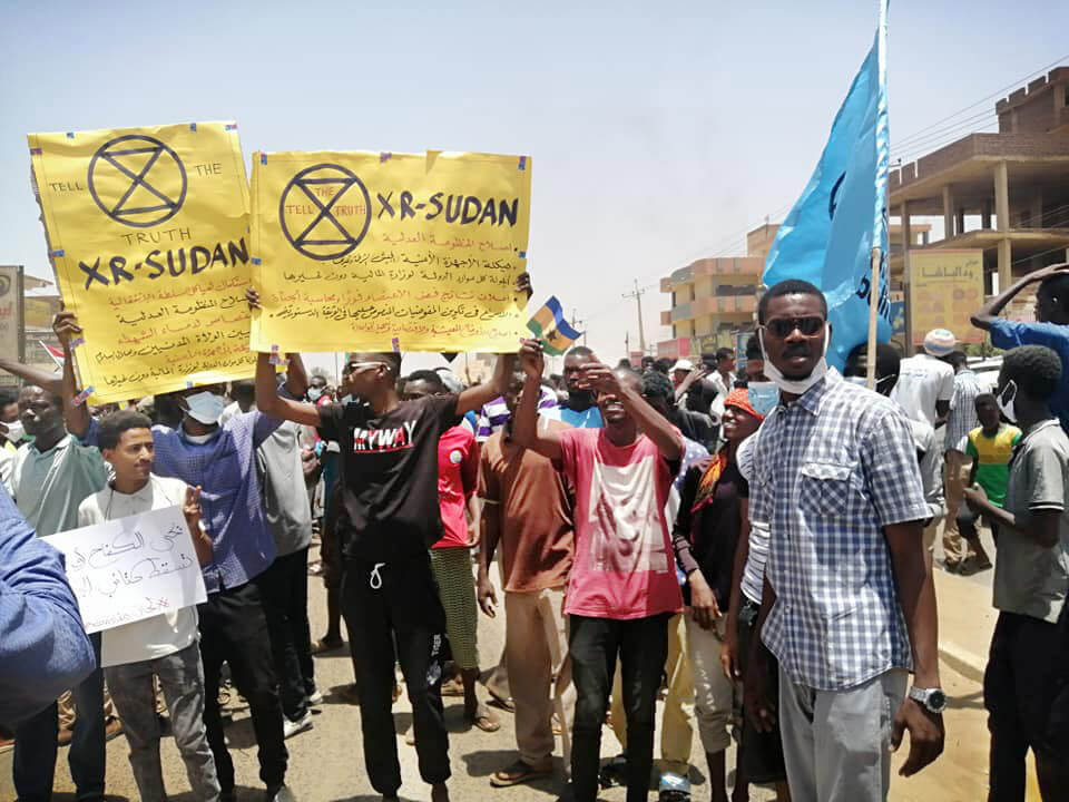 XR Sudan hold up banners during a democracy march