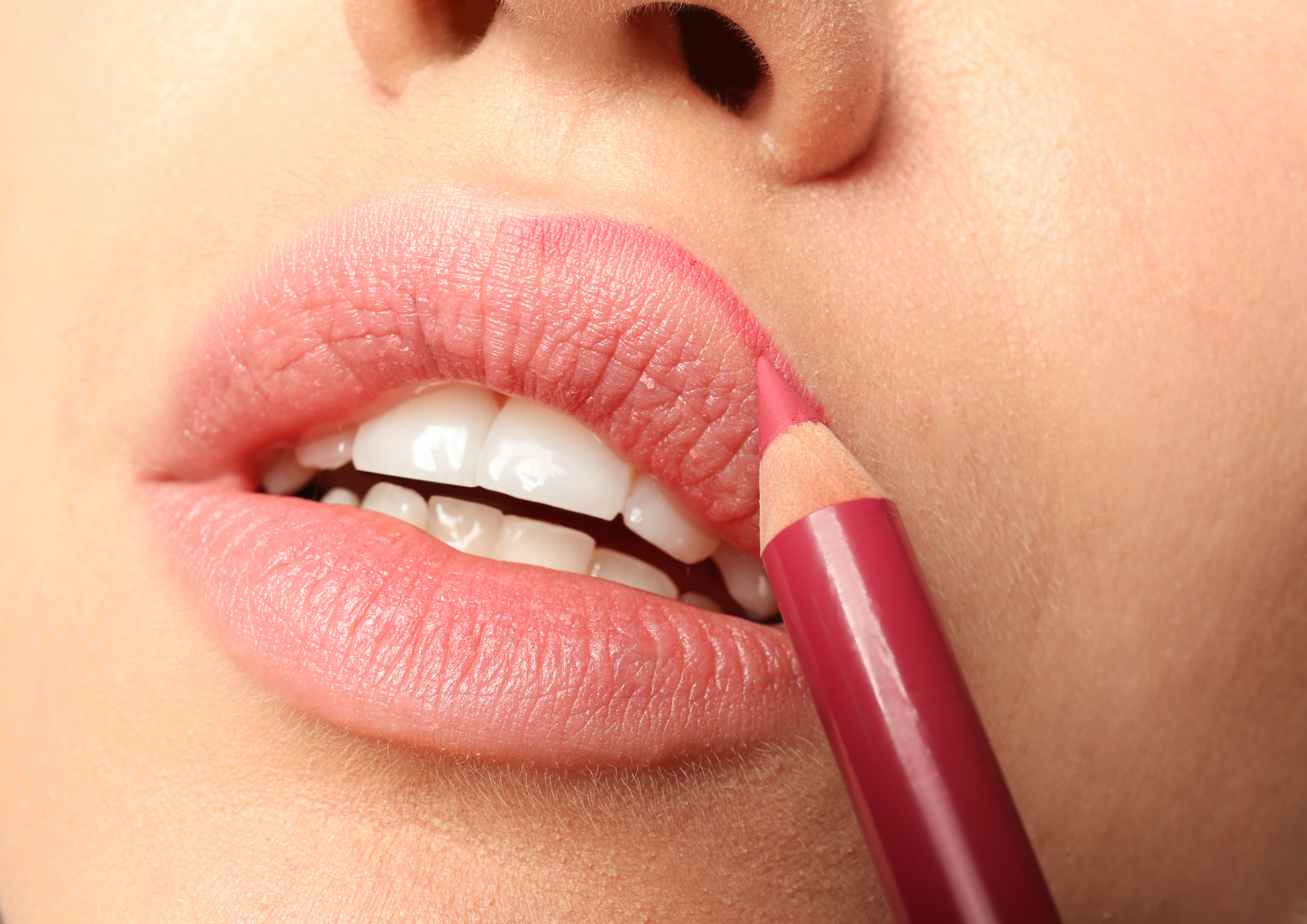 Outlining your lips with lip liner can help prevent feathering.