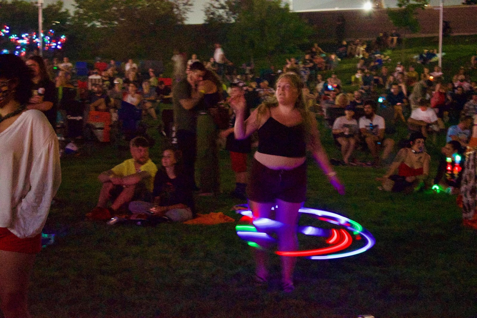 A person in a leotard dancing in front of a crowdDescription automatically generated with low confidence