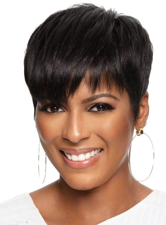 smiling lady wearing classic pixie cut hairstyle with hoop earrings