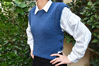 woman wearing a blue knitted vest with buttons on side
