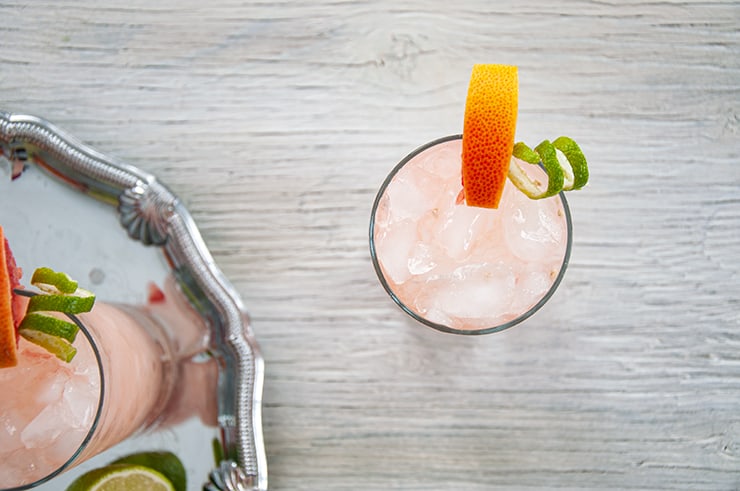 Overhead view of Paloma cocktail and a little bit of a silver platter, showing.