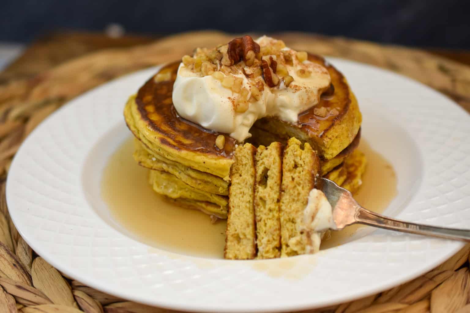 keto pumpkin pancakes stacked on a white plate