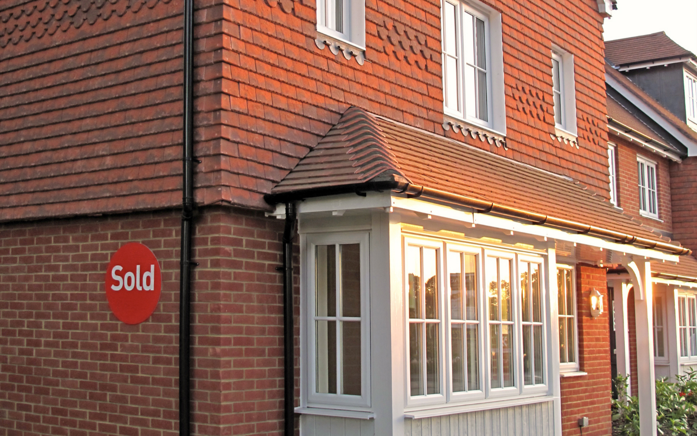 A stop sign in front of a brick building

Description automatically generated