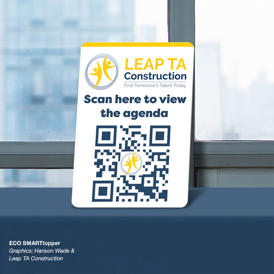 A LEAP table top sign showing a QR code and text that reads "Scan here to view the agenda"