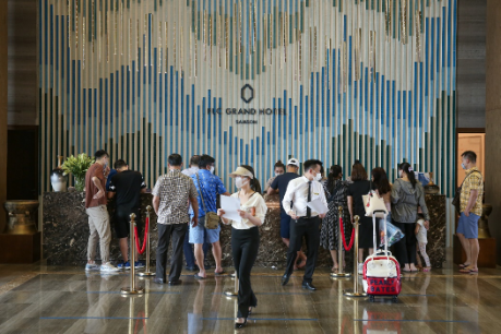 A group of people standing in front of a large map

Description automatically generated with low confidence