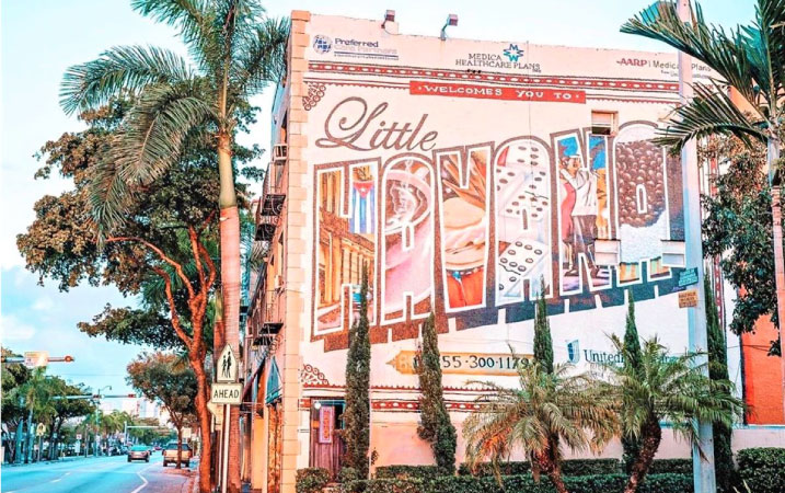 The side of a building in Little Havana painted with a beautiful mural welcoming visitors to the neighborhood.