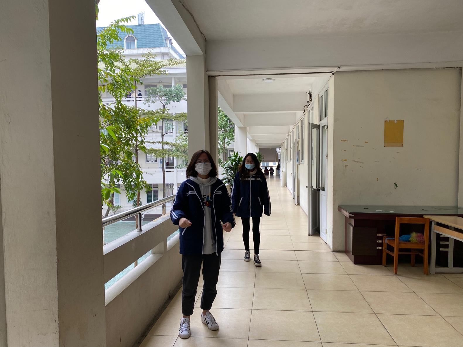 A couple of women walking down a hallway</p>
<p>Description automatically generated with low confidence