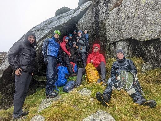 A group of people on a mountain

Description automatically generated with medium confidence