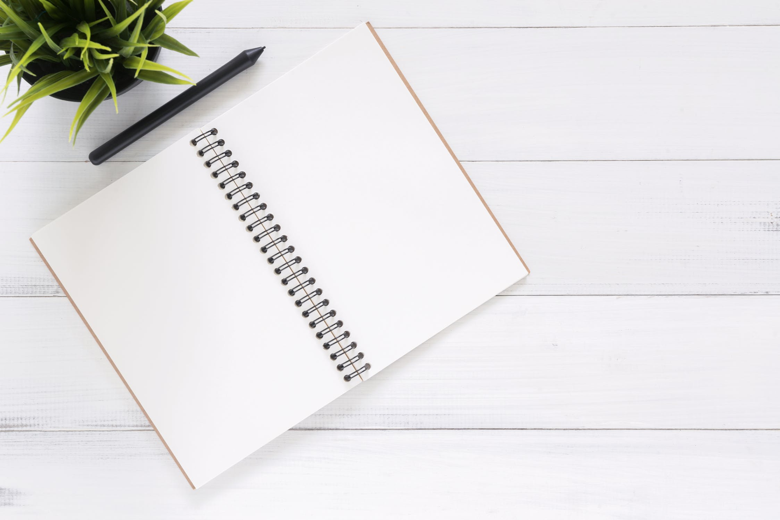 minimalist notebook on desk with pen