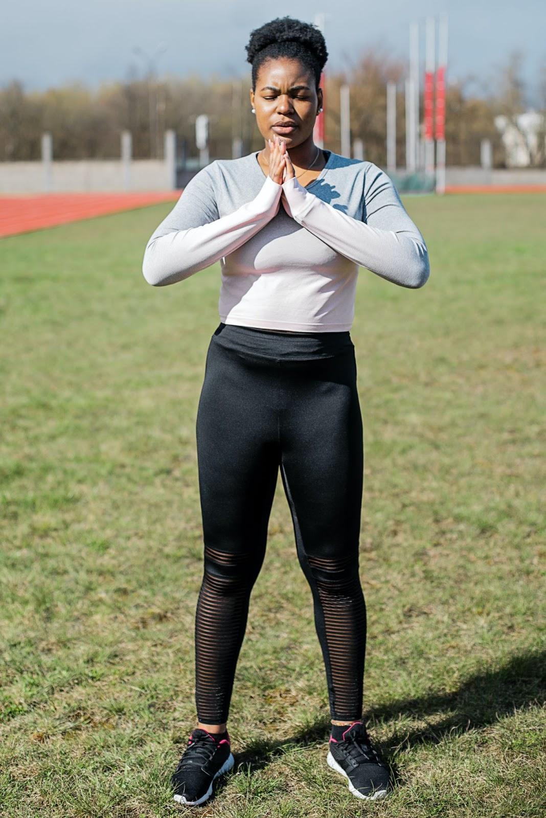 Female Athlete Meditating on the Field
