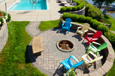 Lake Michigan backyard outdoor living space with fire pit next to water