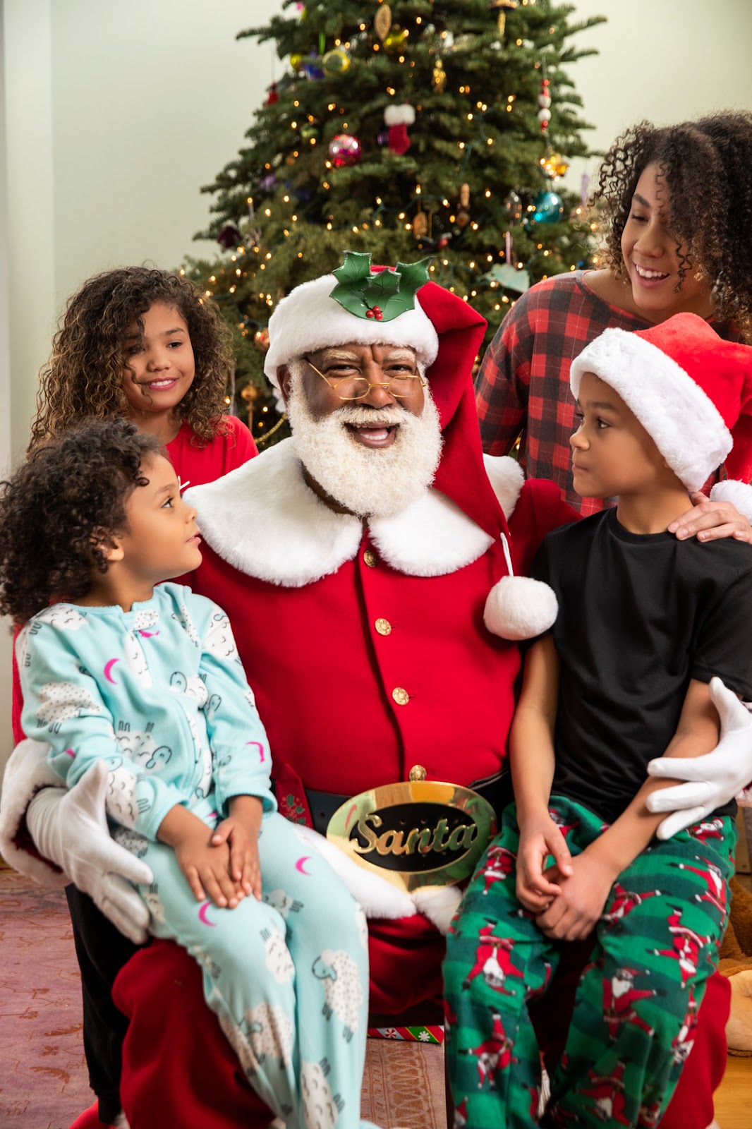 African American Kids & Black Santa Taking Photo