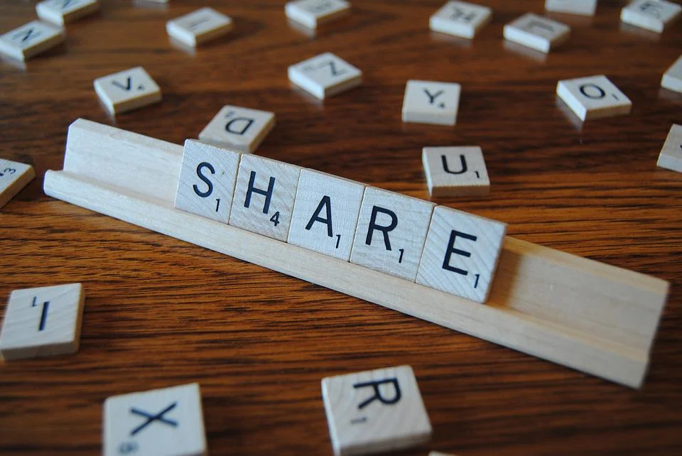 The word "share" written in scrabble tiles 