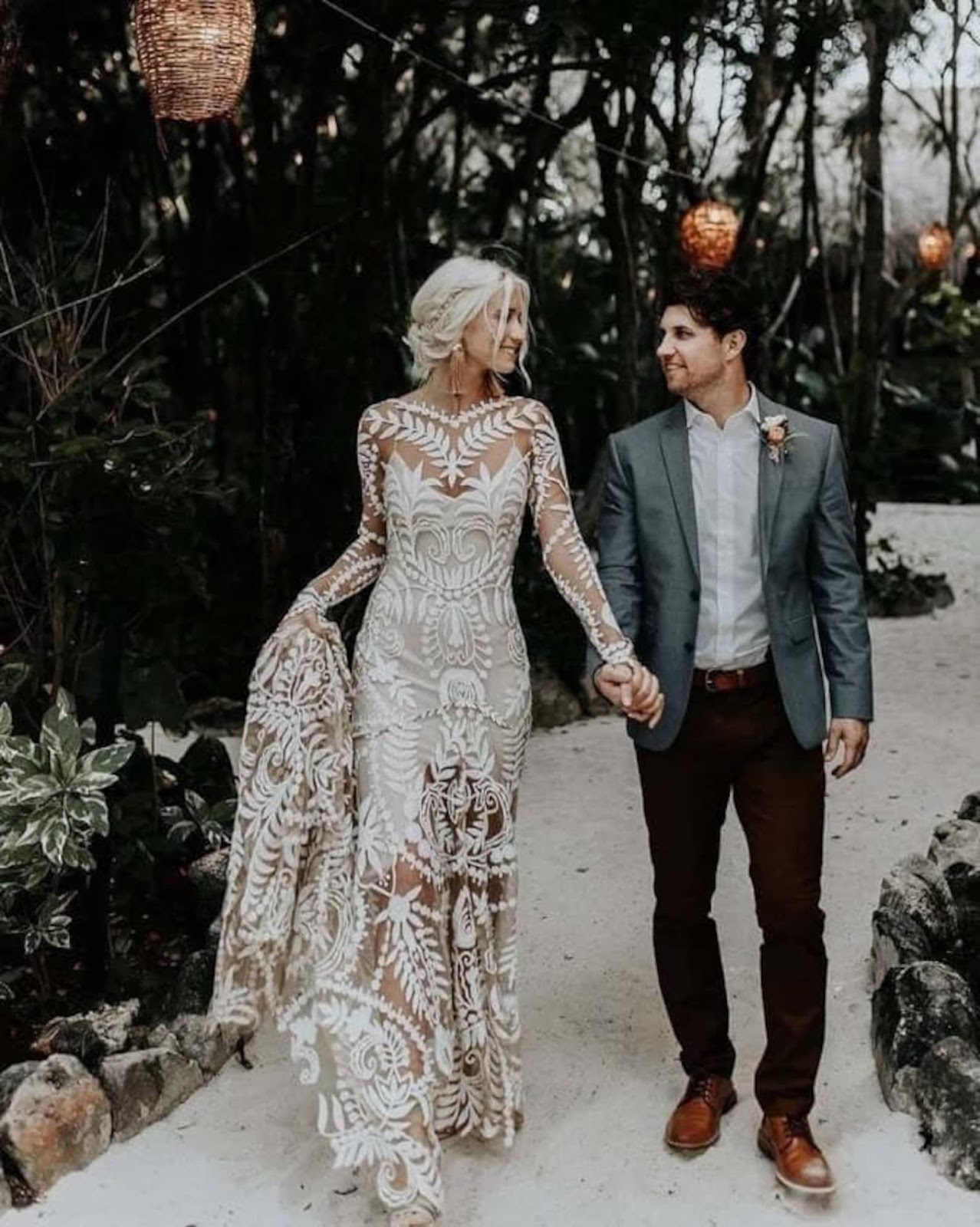 photo of groom and bride with lace wedding dress