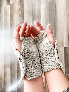 hands wearing a pair of crochet fingerless gloves