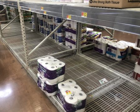 Walmart toilet paper shelves with sparse amounts of product in Cleveland, Ohio.