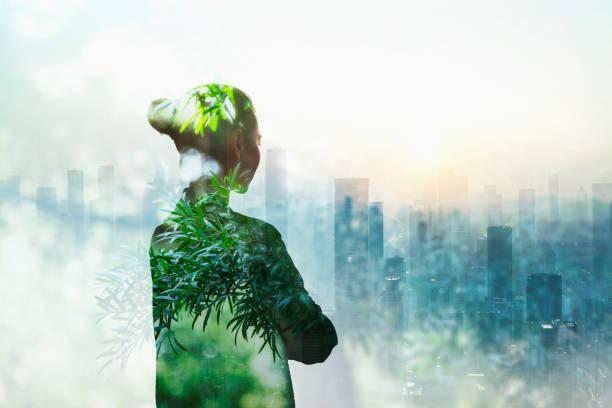 Person standing in contemplation in urban city with nature trees composite Person standing in contemplation in urban city with nature trees composite goals stock pictures, royalty-free photos & images