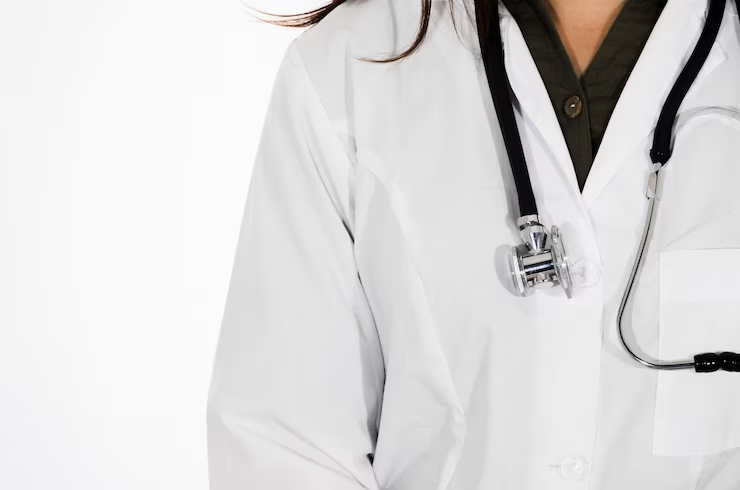 A close-up of a female doctor wearing a stethoscope around her neck, isolated on a white backdrop, representing the first year of medical school.