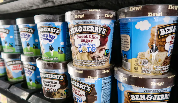 A superstore fridge filled with eye-catching Ben and Jerry's tubs.